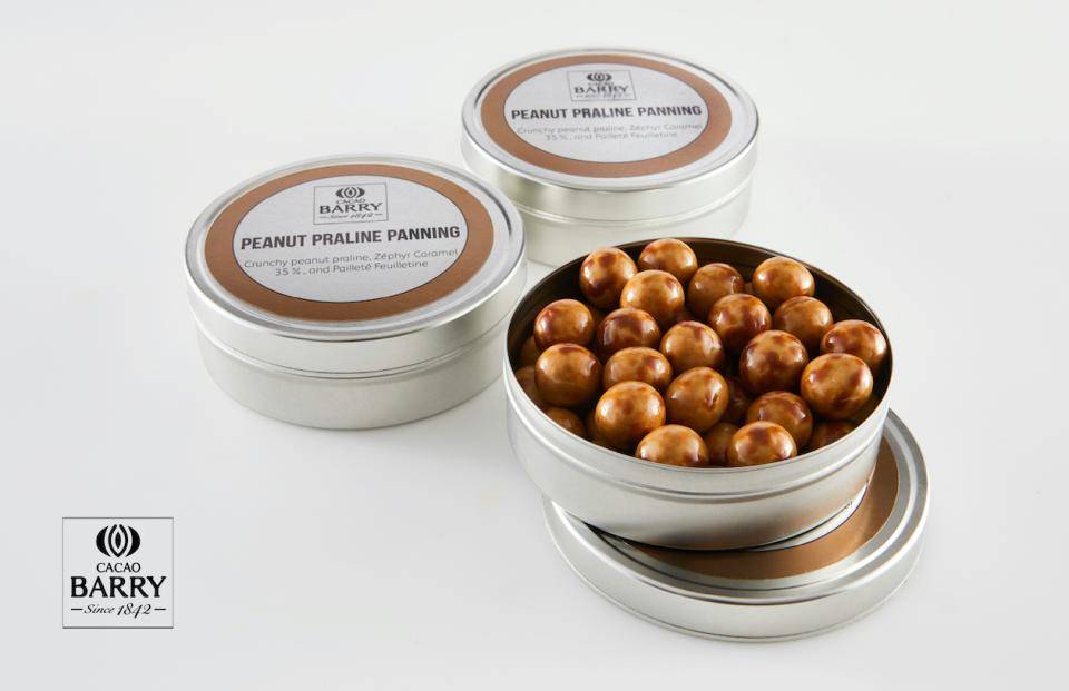 3 small, round metal tins; one is open, showing a brown-colored panned item