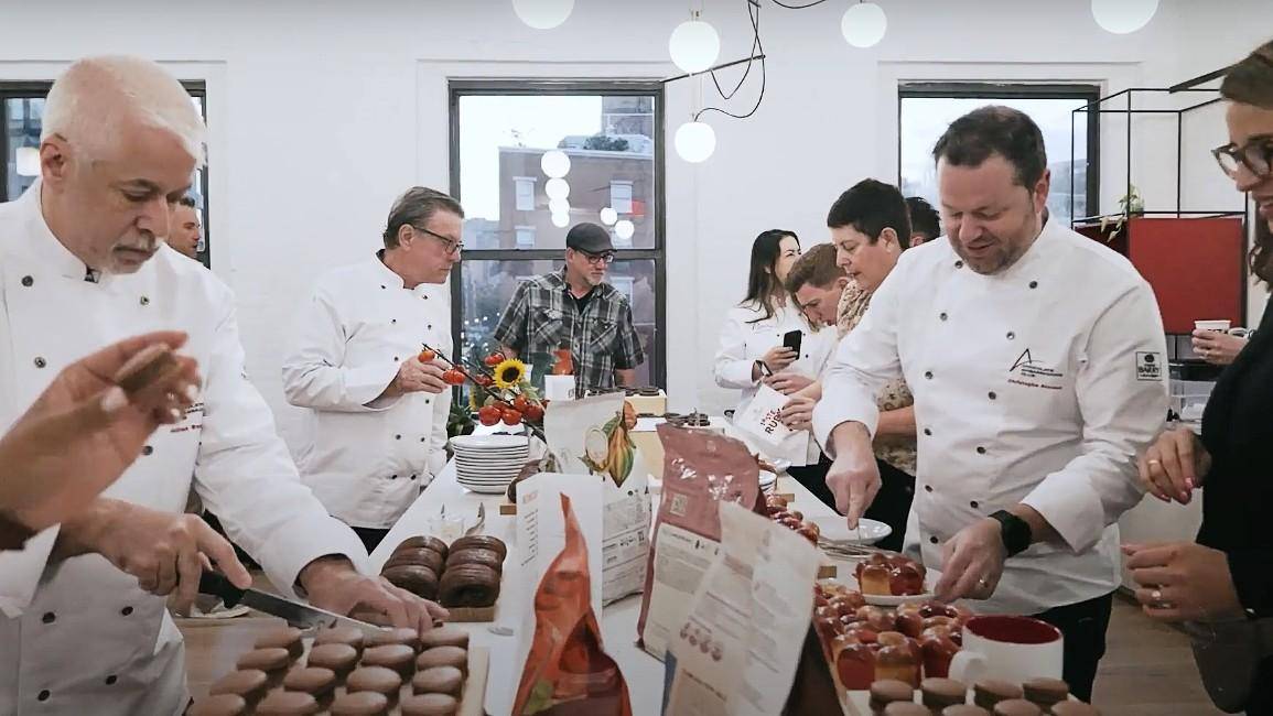 Chefs gathered around a table for a tasting